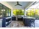 A well-equipped outdoor kitchen offers a built-in grill and bar seating in a screened patio at 7208 Prestbury Cir, Bradenton, FL 34202