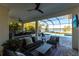 Inviting outdoor living space with seating, pool, and lake view at 7208 Prestbury Cir, Bradenton, FL 34202