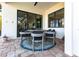 Outdoor dining area on a patio with chairs, a round table, and stylish decor at 7208 Prestbury Cir, Bradenton, FL 34202