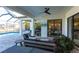 This covered patio includes plenty of seating, a ceiling fan, and access to a swimming pool at 7208 Prestbury Cir, Bradenton, FL 34202
