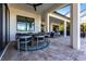 An outdoor patio with a dining table, chairs and access to the outdoor kitchen and bar at 7208 Prestbury Cir, Bradenton, FL 34202