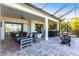 An inviting screened patio features an outdoor kitchen, comfortable seating and water views at 7208 Prestbury Cir, Bradenton, FL 34202