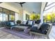 A screened patio features a comfortable seating area with a ceiling fan and water views at 7208 Prestbury Cir, Bradenton, FL 34202