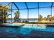 Sparkling pool and spa overlooking serene lake views in a screened enclosure at 7208 Prestbury Cir, Bradenton, FL 34202
