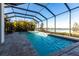 A refreshing pool and spa with sun loungers are surrounded by lush landscaping at 7208 Prestbury Cir, Bradenton, FL 34202