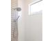 Close-up of a modern shower with sleek fixtures, tiled walls, and a built-in window at 7208 Prestbury Cir, Bradenton, FL 34202