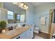 Bright bathroom features a double vanity, shower with glass door, and decorative accents at 7311 64Th St E, Palmetto, FL 34221