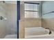 Serene bathroom featuring a tub, a tiled shower, and a bright window at 7311 64Th St E, Palmetto, FL 34221