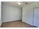 Vacant bedroom with wood-look floors, a ceiling fan, and a double-door closet at 7311 64Th St E, Palmetto, FL 34221