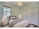 Light-filled bedroom with a queen bed, gray accents, modern lighting and a large closet at 7311 64Th St E, Palmetto, FL 34221