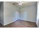 This is a vacant bedroom with wood-look floors, a ceiling fan, and closet at 7311 64Th St E, Palmetto, FL 34221