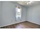 Bright vacant bedroom with wood-look floors, a ceiling fan, and bright window at 7311 64Th St E, Palmetto, FL 34221