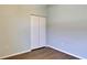 This is a secondary bedroom with wood-look floors and double-door closet at 7311 64Th St E, Palmetto, FL 34221
