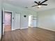 Well-lit bedroom with hardwood floors, a ceiling fan, and multiple access doors at 7311 64Th St E, Palmetto, FL 34221