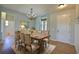 Traditional dining room with chandelier, wood table with seating for six, and adjacent entry and powder room at 7311 64Th St E, Palmetto, FL 34221