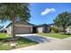 Single-story home with a spacious driveway, well-kept lawn, and attractive landscaping in a sunny neighborhood at 7311 64Th St E, Palmetto, FL 34221