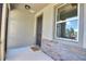 Covered entryway with a 'Welcome' mat and a window with decorative trim, offering a warm invitation at 7311 64Th St E, Palmetto, FL 34221