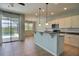 Bright kitchen with counter seating, pendant lights, and views to the backyard pool area at 7311 64Th St E, Palmetto, FL 34221
