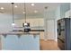 Spacious kitchen features a breakfast bar, pendant lighting, and modern stainless steel appliances at 7311 64Th St E, Palmetto, FL 34221