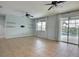 Bright living room features tile floors, ceiling fans, and sliding glass doors leading to the pool at 7311 64Th St E, Palmetto, FL 34221