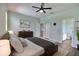 Spacious main bedroom featuring a large bed, stylish decor, and access to the bathroom at 7311 64Th St E, Palmetto, FL 34221
