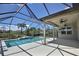 Relax by the pool on this screened-in lanai with lush landscaping at 7311 64Th St E, Palmetto, FL 34221