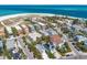 Stunning aerial view of beach homes with lush landscaping and access to the beautiful blue ocean water at 799 Jacaranda Rd, Anna Maria, FL 34216