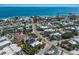 Scenic aerial view of residential neighborhood with vibrant homes, lush greenery, and direct ocean access at 799 Jacaranda Rd, Anna Maria, FL 34216