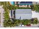 Aerial view of home featuring a metal roof, solar panels, and a private backyard oasis with a pool at 799 Jacaranda Rd, Anna Maria, FL 34216