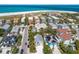 Aerial view of coastal homes with private pools, lush landscaping, and easy access to the beach and ocean at 799 Jacaranda Rd, Anna Maria, FL 34216
