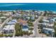 Beautiful aerial view of colorful coastal homes with pools and private beach access on a sunny day at 799 Jacaranda Rd, Anna Maria, FL 34216