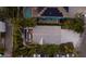 Overhead view of home with backyard pool, patio, modern design, and lush tropical landscaping at 799 Jacaranda Rd, Anna Maria, FL 34216