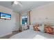 Comfortable bedroom with a ceiling fan, flat screen TV, and views of the outdoors at 799 Jacaranda Rd, Anna Maria, FL 34216