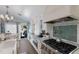 Modern kitchen with stainless steel appliances, marble countertops, and an open layout at 799 Jacaranda Rd, Anna Maria, FL 34216