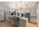 Bright kitchen featuring a large island with bar seating, marble countertops, and modern lighting at 799 Jacaranda Rd, Anna Maria, FL 34216