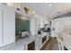 A bright gourmet kitchen with white cabinets, tile backsplash, and stainless steel appliances at 799 Jacaranda Rd, Anna Maria, FL 34216