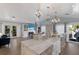 An open concept kitchen and living room with marble countertops and luxury finishes at 799 Jacaranda Rd, Anna Maria, FL 34216