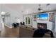 Cozy living room featuring a fireplace, TV, and double doors leading to a charming outdoor balcony at 799 Jacaranda Rd, Anna Maria, FL 34216