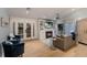 Comfortable living room with hardwood floors, a cozy fireplace, TV, and ample seating at 799 Jacaranda Rd, Anna Maria, FL 34216