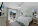 Spacious main bedroom with ensuite, ceiling fan, and balcony access at 799 Jacaranda Rd, Anna Maria, FL 34216