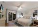 Serene main bedroom with hardwood floors, a ceiling fan, balcony access and soft natural light at 799 Jacaranda Rd, Anna Maria, FL 34216
