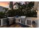 Outdoor kitchen with built-in grill and stainless steel appliances, ideal for outdoor cooking at 799 Jacaranda Rd, Anna Maria, FL 34216
