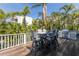 Outdoor patio with seating, grill, and lush tropical landscaping for entertaining at 799 Jacaranda Rd, Anna Maria, FL 34216