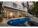 Outdoor living space featuring an inviting pool, lounge chairs, and an outdoor TV for relaxation and entertaining at 799 Jacaranda Rd, Anna Maria, FL 34216