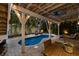 Outdoor living space featuring a pool, lounge chairs, ceiling fan, and lush tropical landscaping at 799 Jacaranda Rd, Anna Maria, FL 34216