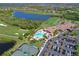 Aerial view of resort-style community amenities with clubhouse, pool, tennis courts, and golf course views at 8105 Grand Estuary Trl # 105, Bradenton, FL 34212