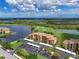 Scenic aerial shot of a condo complex situated beside a golf course and a picturesque lake at 8105 Grand Estuary Trl # 105, Bradenton, FL 34212