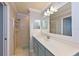 Fresh bathroom featuring a glass door shower, vanity with generous counter space, and modern lighting at 8105 Grand Estuary Trl # 105, Bradenton, FL 34212