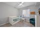 This bright room has a bed, hardwood floors, a window, and an aqua-colored chair at 8105 Grand Estuary Trl # 105, Bradenton, FL 34212