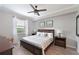 Comfortable primary bedroom featuring a ceiling fan and a view of the green outdoors at 8105 Grand Estuary Trl # 105, Bradenton, FL 34212